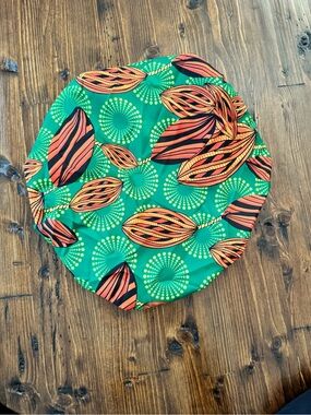 Vibrant Green African Print Satin Lined Bonnet with Orange Leaf Pattern